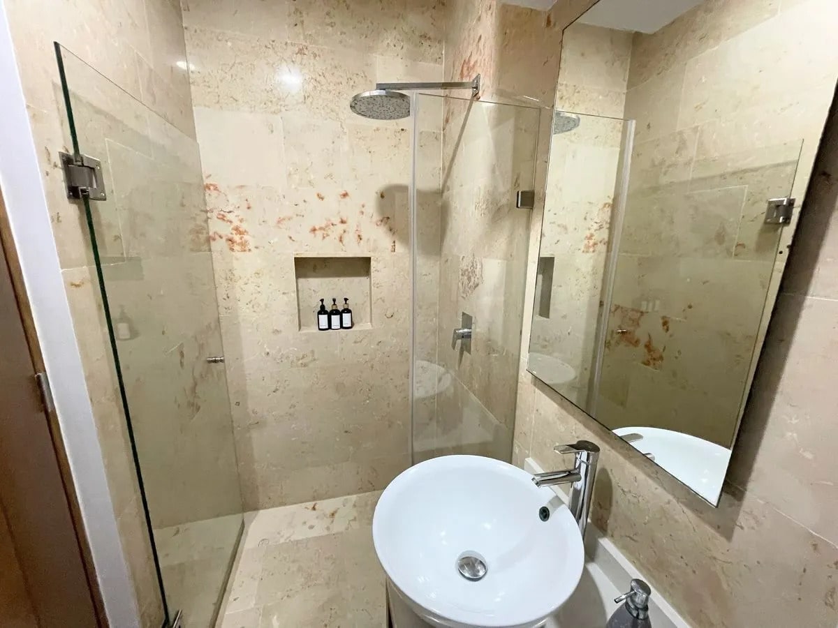 un baño completo y un lavamanos en a perfect place playa del carmen