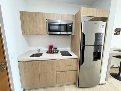 un refrigerador mediano y una parrilla electrica en a perfect place playa del carmen