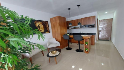 una cocina y una sala en vanessa 20 playa del carmen