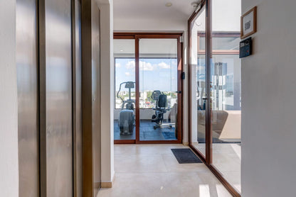 un elevador y un gimnasio al fondo en tzalam residences playa del carmen