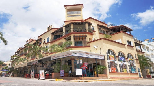 una fachada de un edificio con departamentos en renta en magic paradise playa del carmen