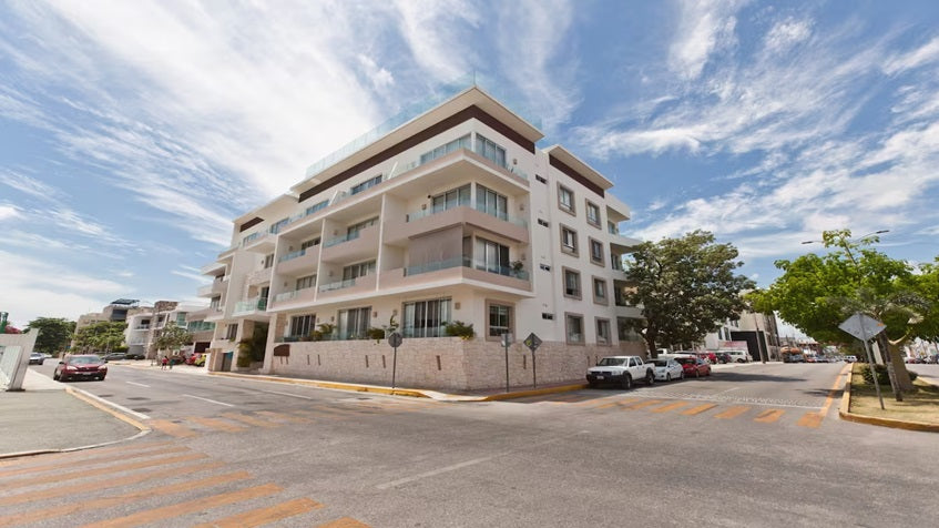 una fachada de un edificio de departamentos en el centro en horizonte 34 playa del carmen