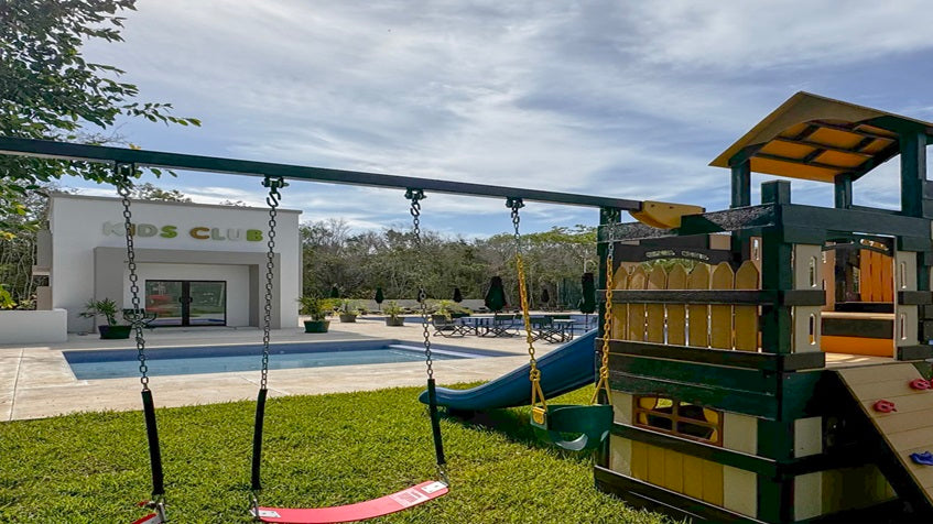 un area de juegos para niños y un kids club en bosques de ciudad mayakoba