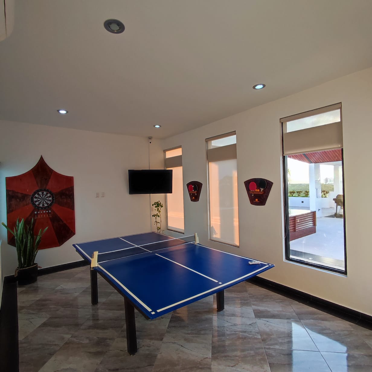 una sala de juegos con una mesa de ping pong en playa aurora playa del carmen