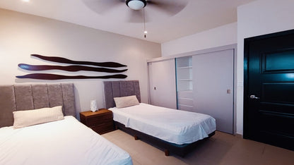 una recamara con 2 camas individuales y un closet grande en selvanova residencial playa del carmen