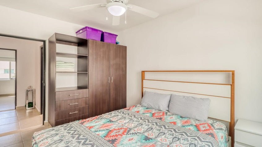 una recamara con un closet de madera en residencial lunamar playa del carmen