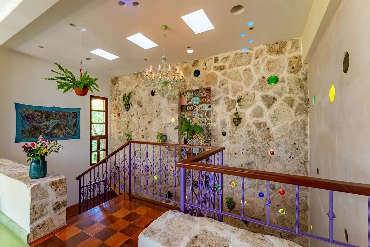 unas escaleras con detallados en las paredes de piedras de colores en xcaret playa del carmen