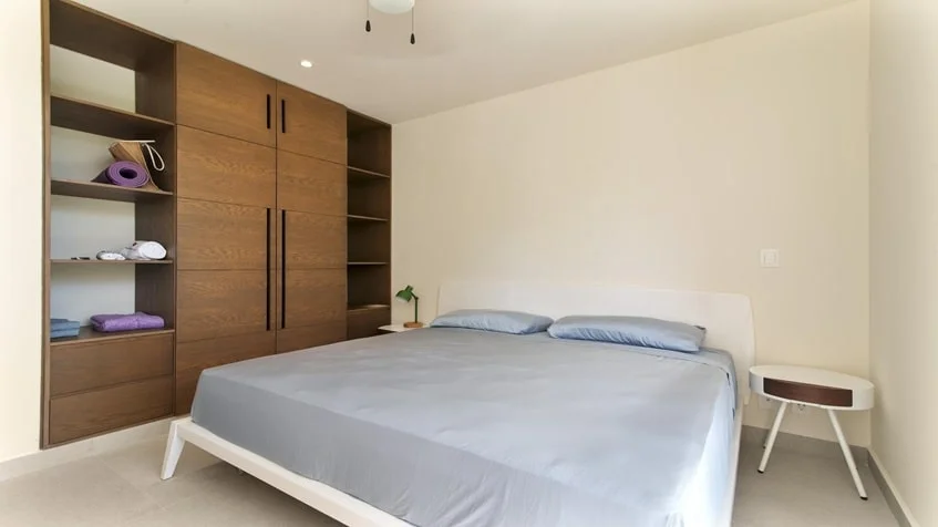una cama king size, un closet de madera grande en Santamar Akumal