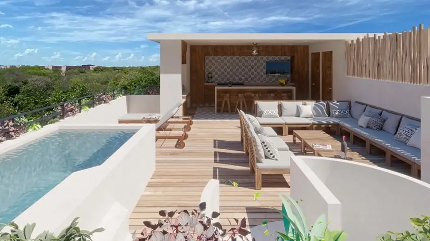 una terraza con alberca y area lounge en muwan tulum