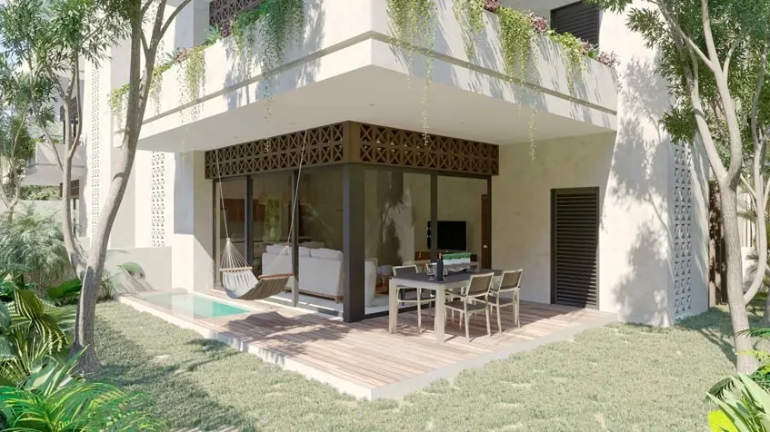 un area de jardin con una terraza y un jacuzzi en muwan tulum