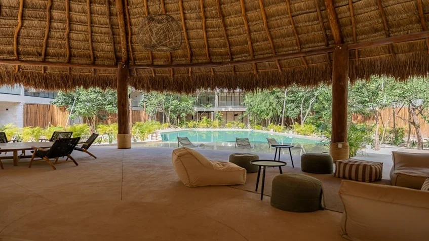 una alberca con area de tumbonas en samsara tulum