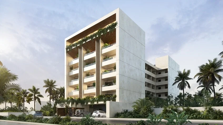 una fachada de un edificio nuevo con palmeras alrededor en studio 34 playa del carmen
