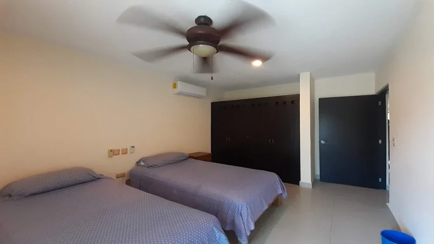 una recamara con 2 camas matrimoniales y un closet grande en edificio palmeiras playa del carmen