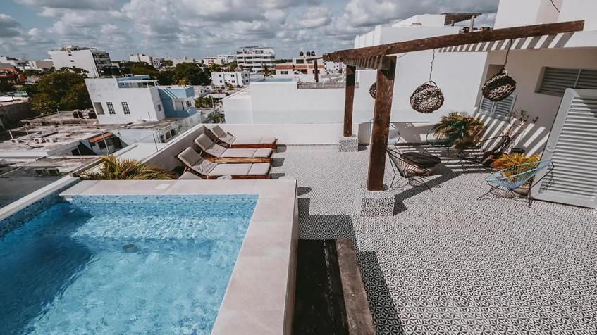 una terraza con solarium en casa mora suites playa del carmen