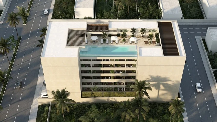 una vista aerea de una alberca en un edificio con departamentos en venta en studio 34 playa del carmen